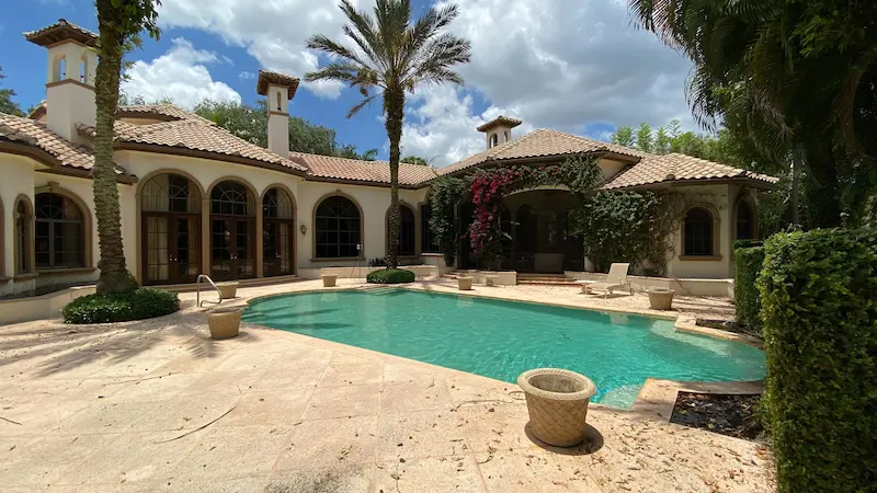 Exterior 3D laser scanning at a Fine Home residance with a pool and palm trees.