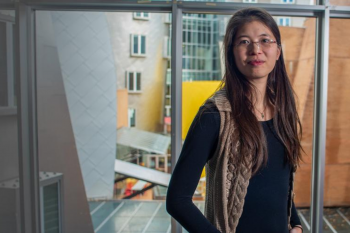an image of Cathy Wu standing in front of a window in the Stata building