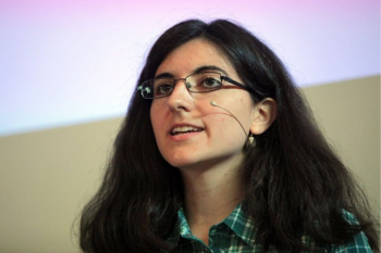 a photo of Tamara Broderick giving a talk with a headset mic on