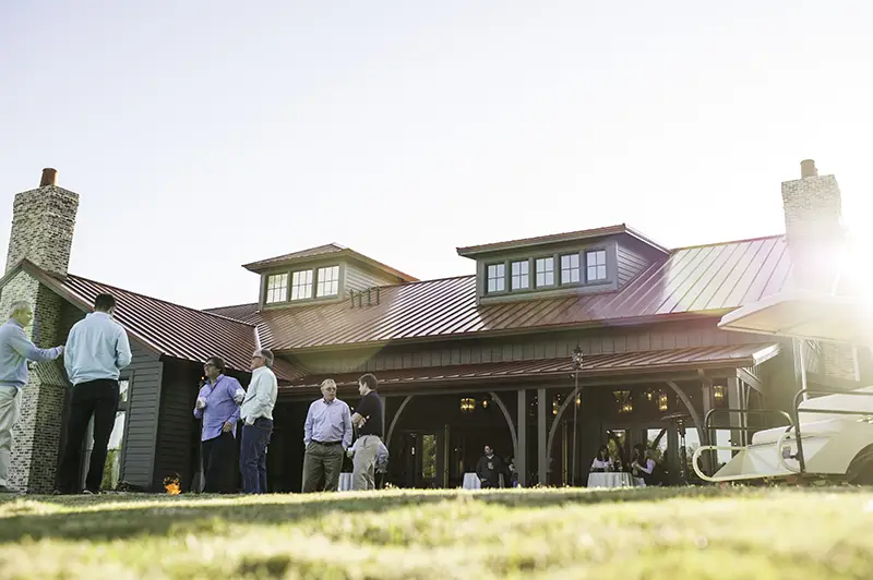 Group of golfers at an event hanging out in front of an event space