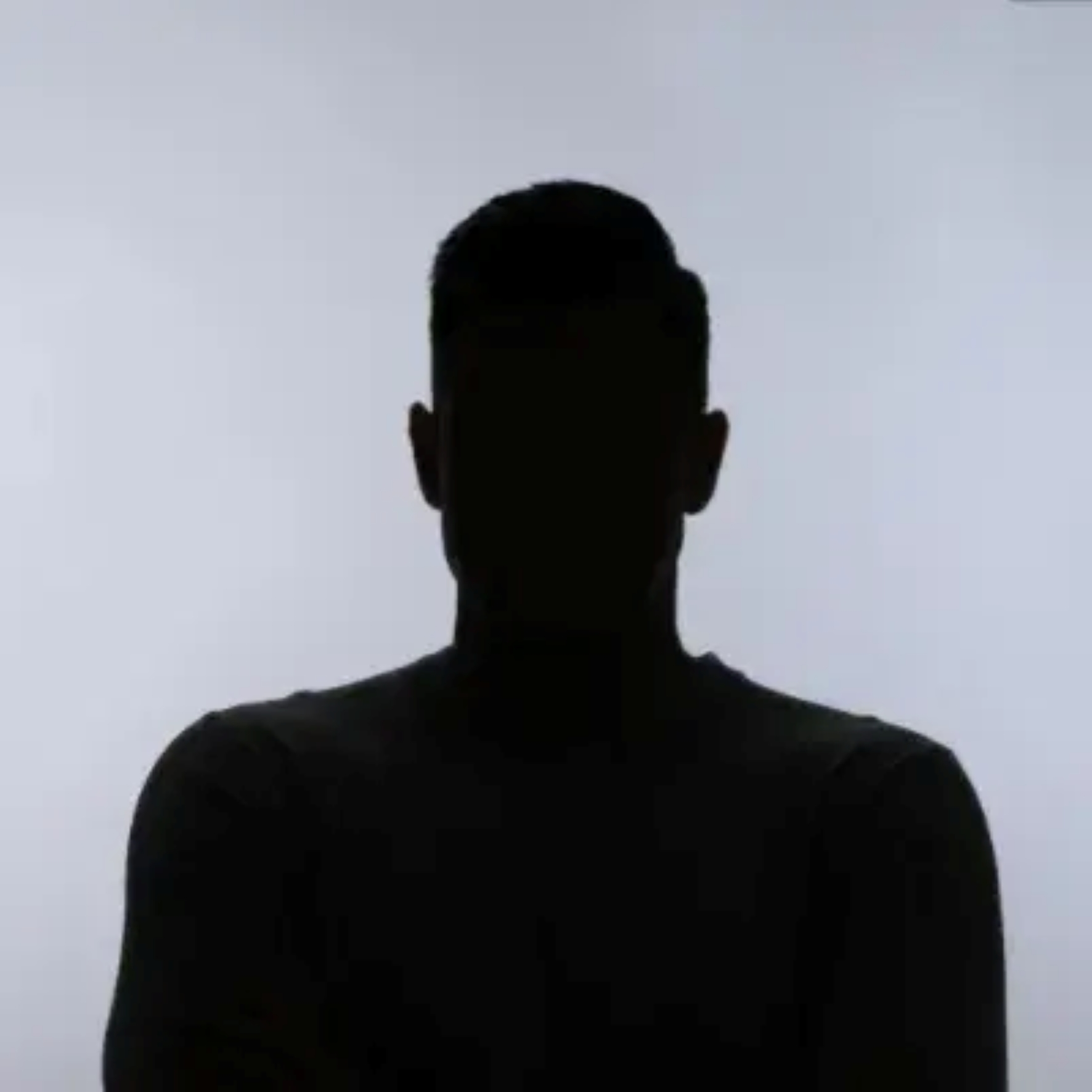 Silhouette of Sheraz Mohsin with folded arms in front of a light background, face not recognizable.