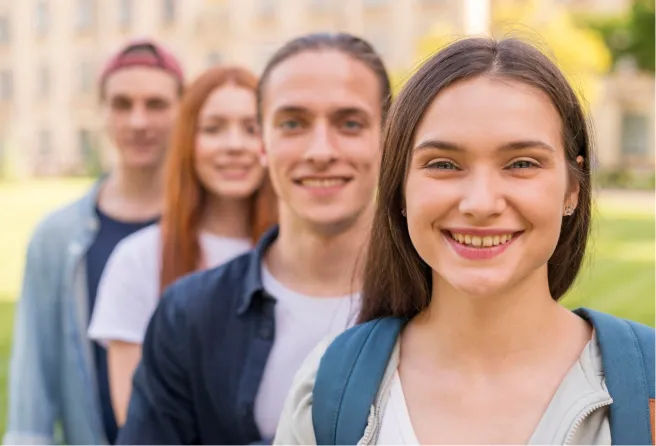 Four young people standing in row