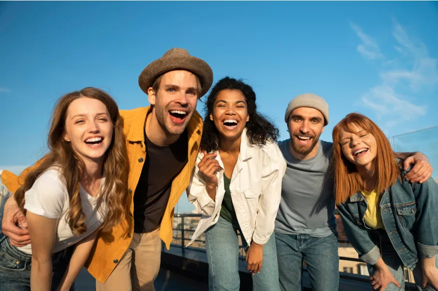 Five young people posing for camera