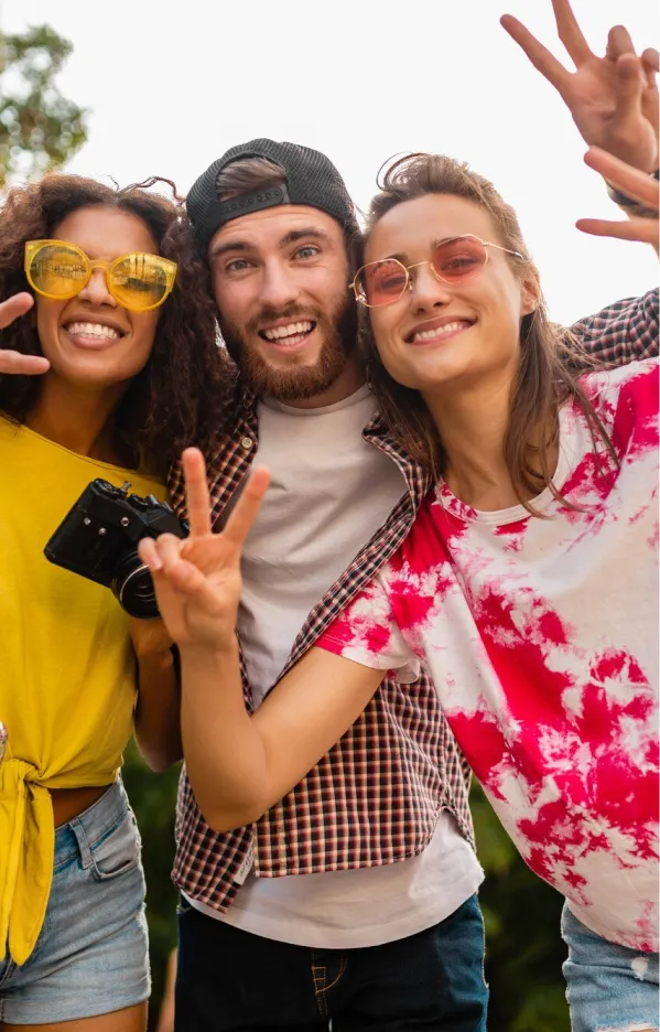 Three young people posing for camera