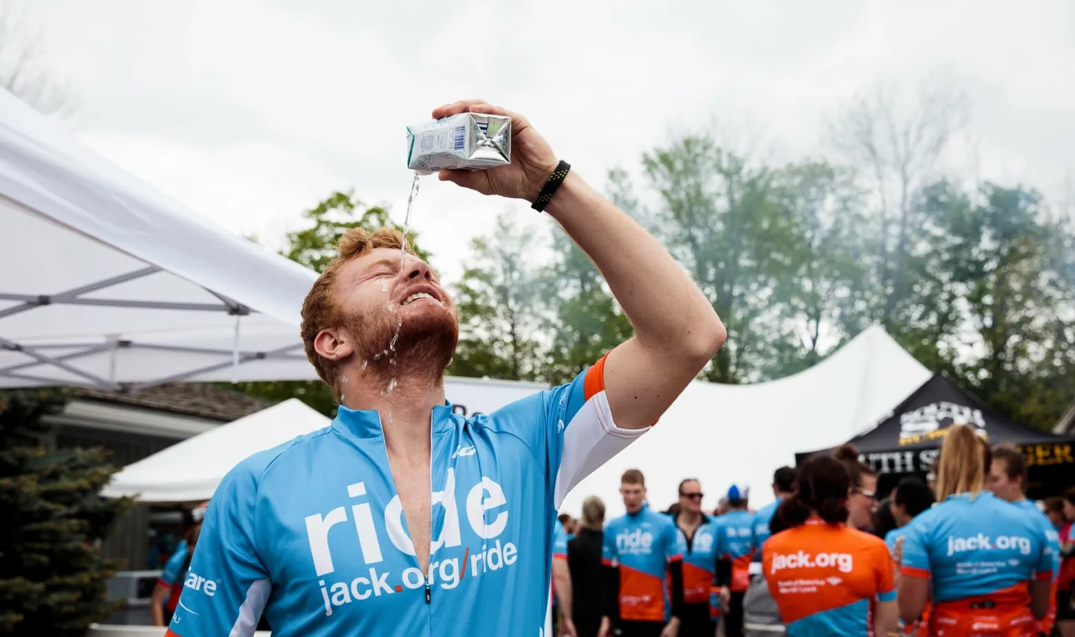 Jack Ride participant cooling off by pouring a bottle of water on his head