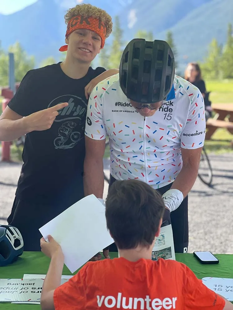 Volunteer talking to two riders