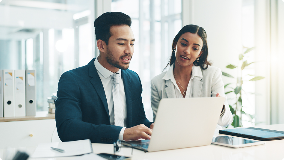 two person talking in office with laptop