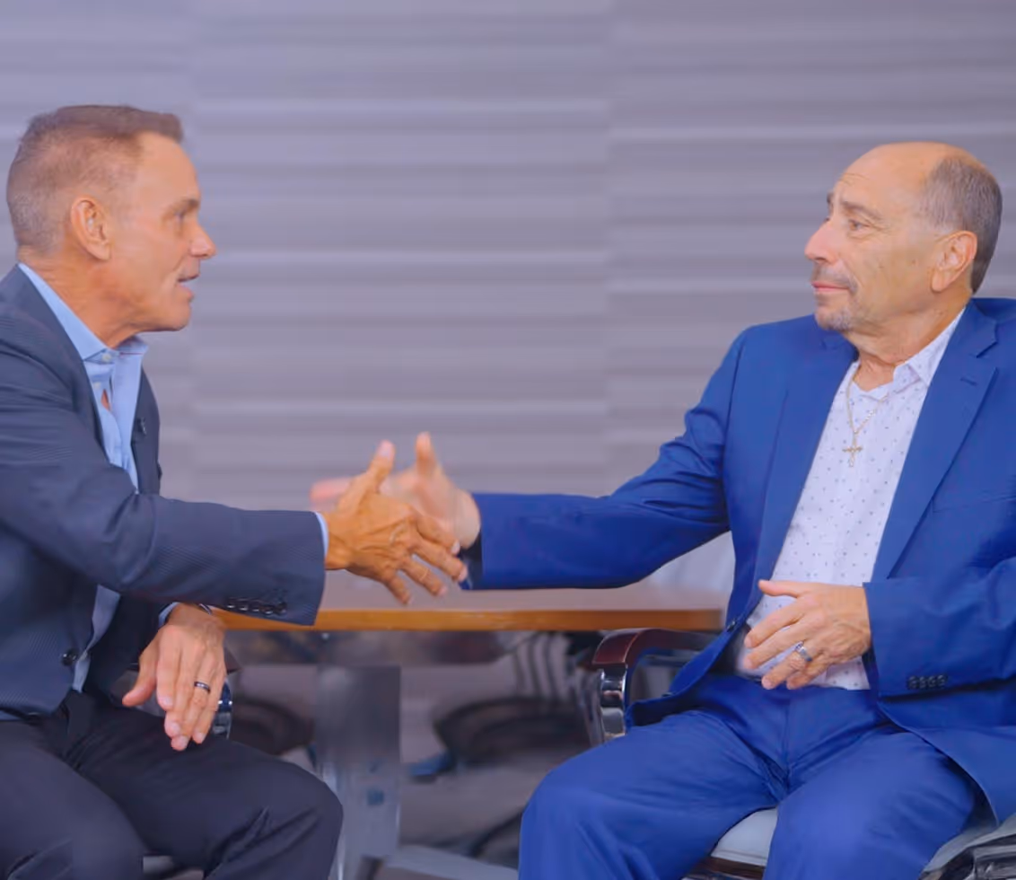 Kevin Harrington and Kenny Michaels shaking hands
