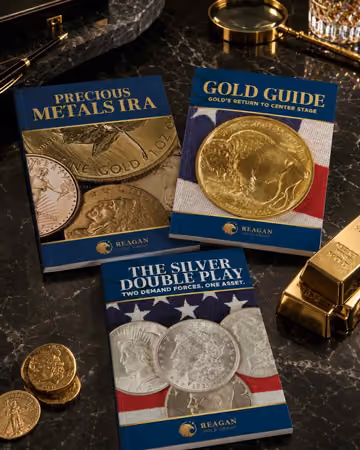 Reagan Gold Group precious metals IRA, gold guide, and silver guide displayed with gold coins and bullion