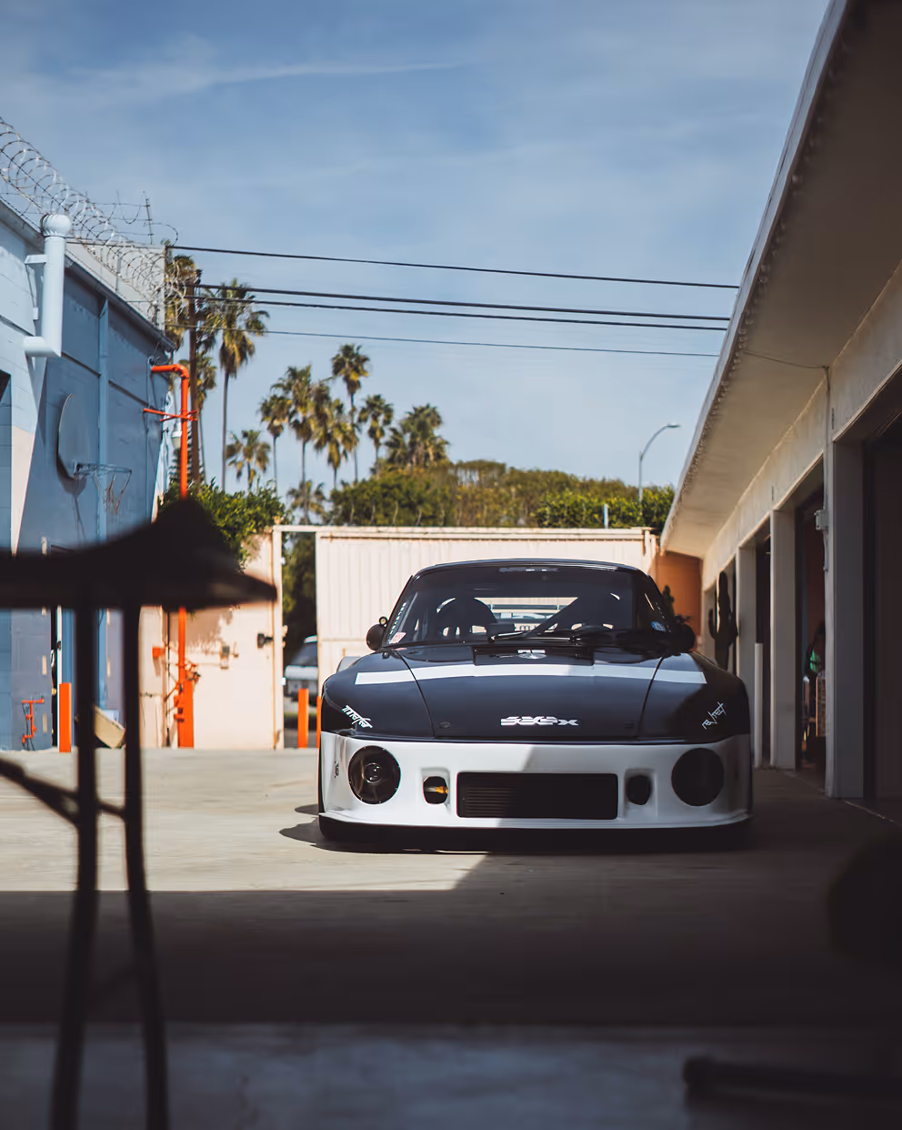 Race Service — modified widebody sports car parked in an alley