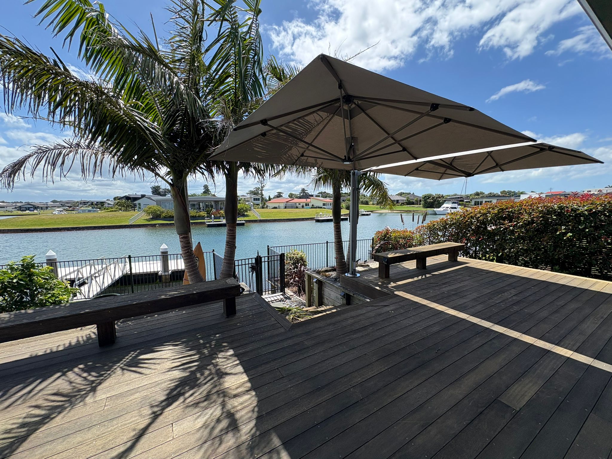 Dual outdoor umbrella setup in Bream Bay, installed by Shadeland