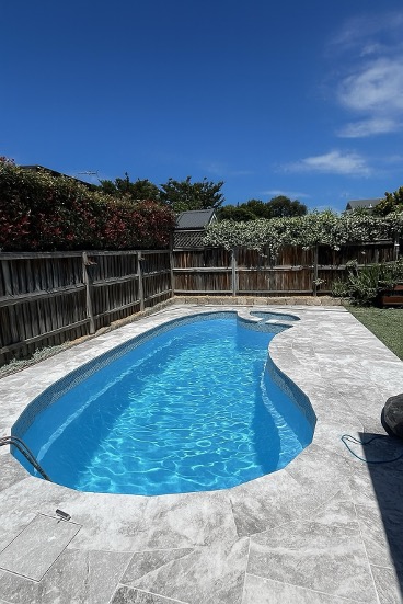 Fibreglass Pool Resurfaced in Sydney with new natural stone pool coping and paving