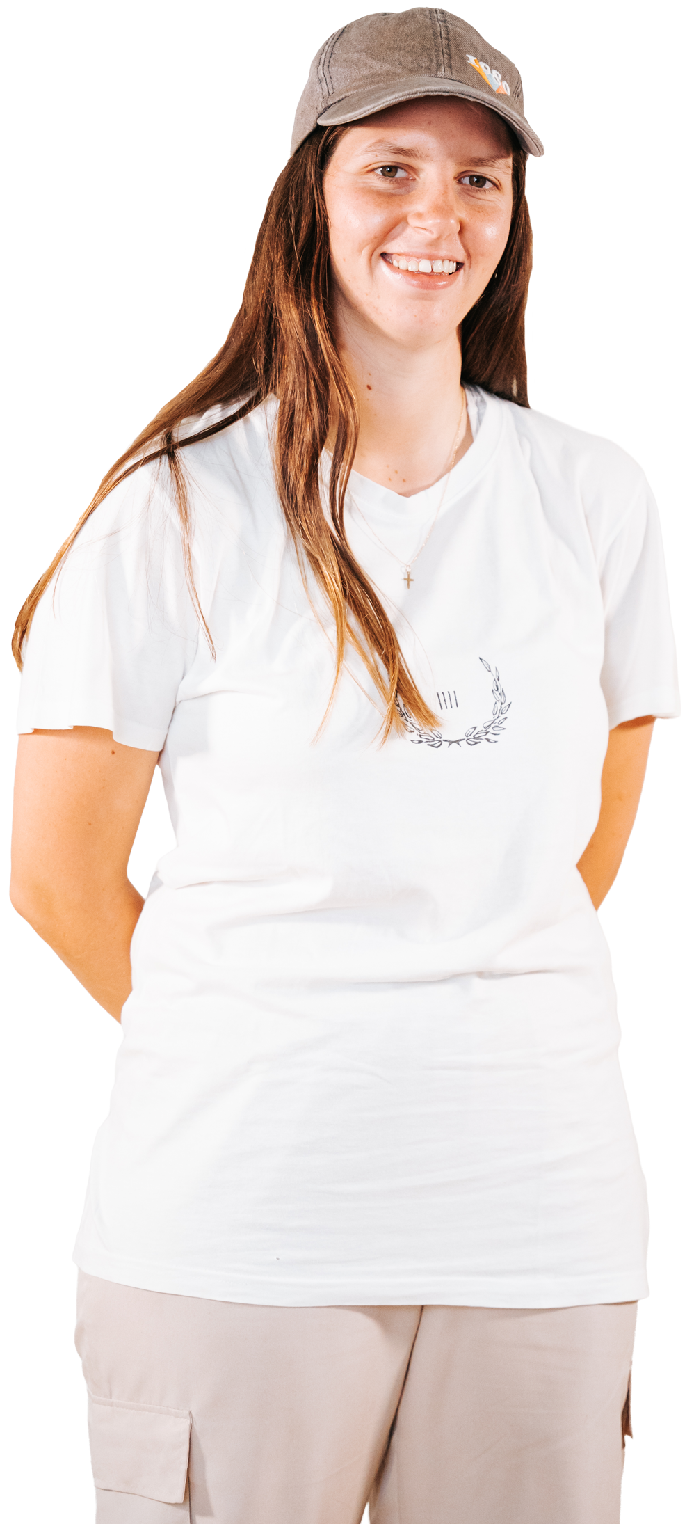 Photo of a lady smiling into the camera wearing a white shirt and light beige pants.