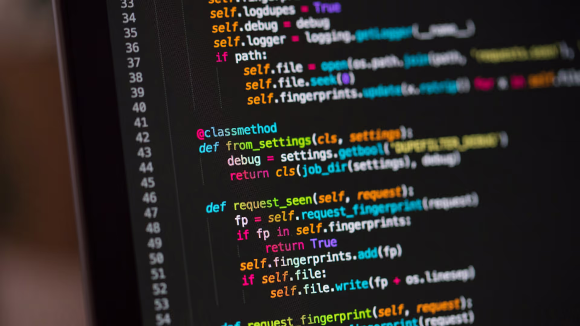 Close up of a laptop screen with code displayed.