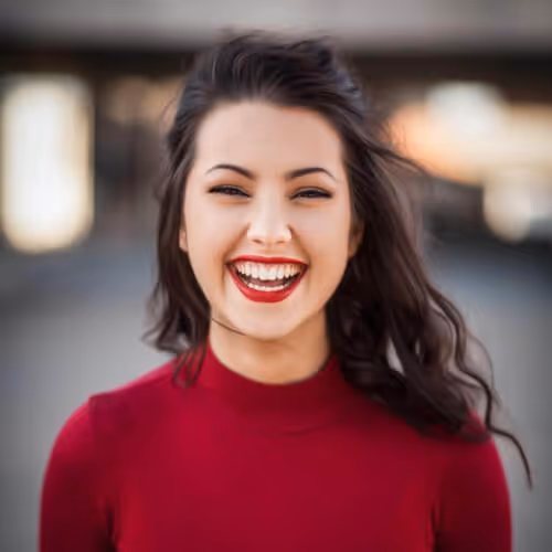 close up photo smiling woman with red top