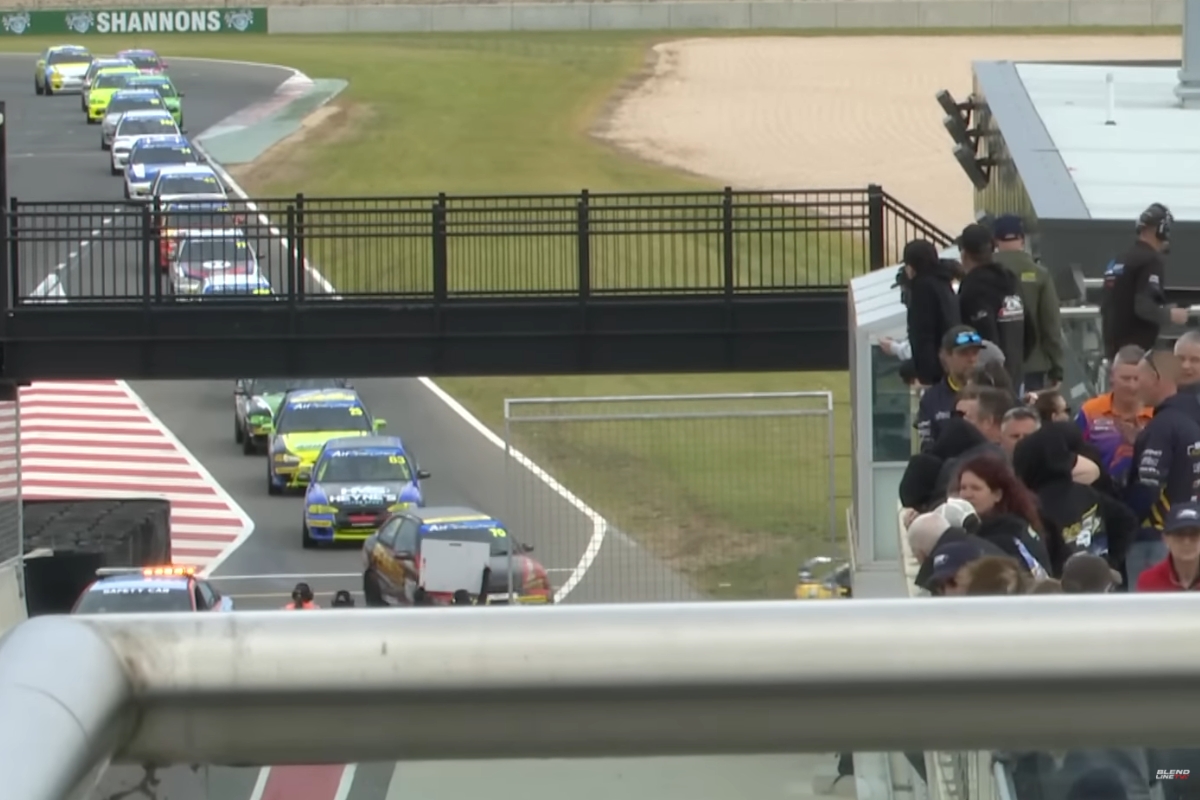 Spectators watching race cars on track