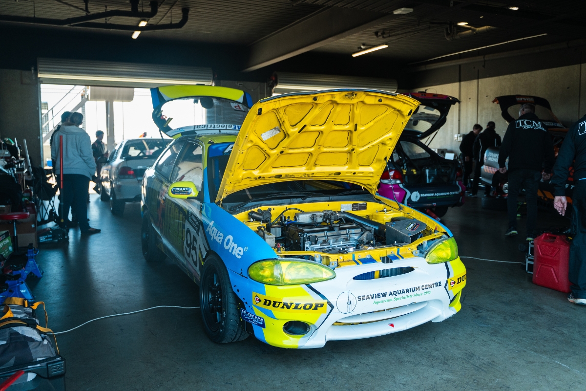 Race car in garage with the bonnet open