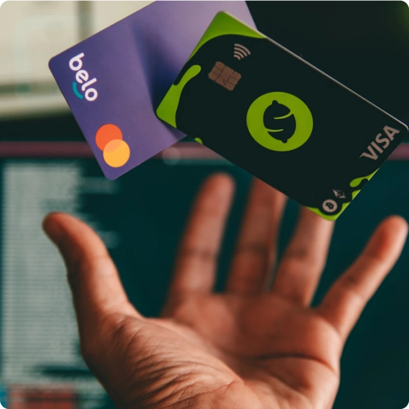 Hand holding Visa and Mastercard debit cards for digital transactions