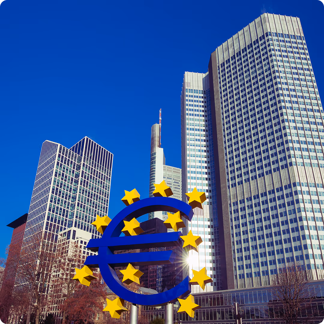 Euro currency symbol sculpture in Frankfurt financial district with modern skyscrapers in the background