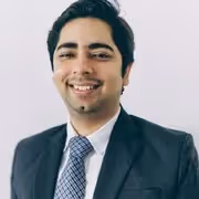 A man wearing glasses and a jacket.