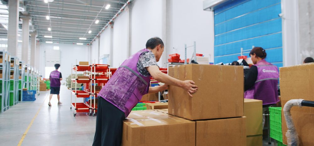 Warehouse staff receiving cartons of stock