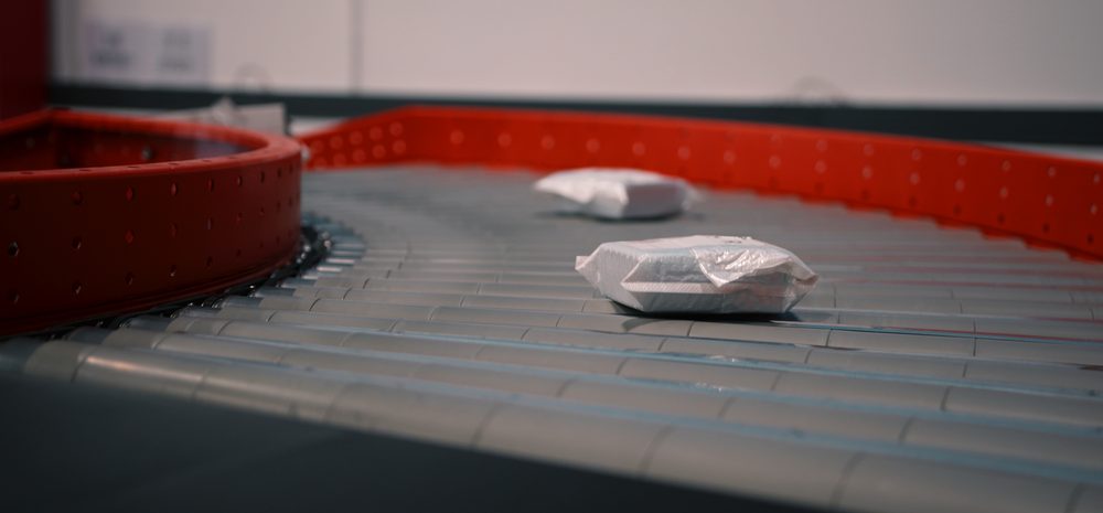 Packed parcels moving along the conveyor
