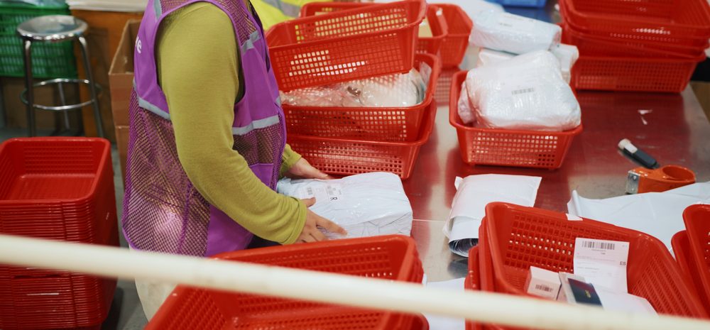 Orders being picked and packed into totes