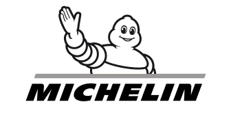 Mascotte Michelin souriante, personnage de pneu blanc avec un bras levé en signe de salutation au-dessus du nom Michelin en lettres majuscules noires.