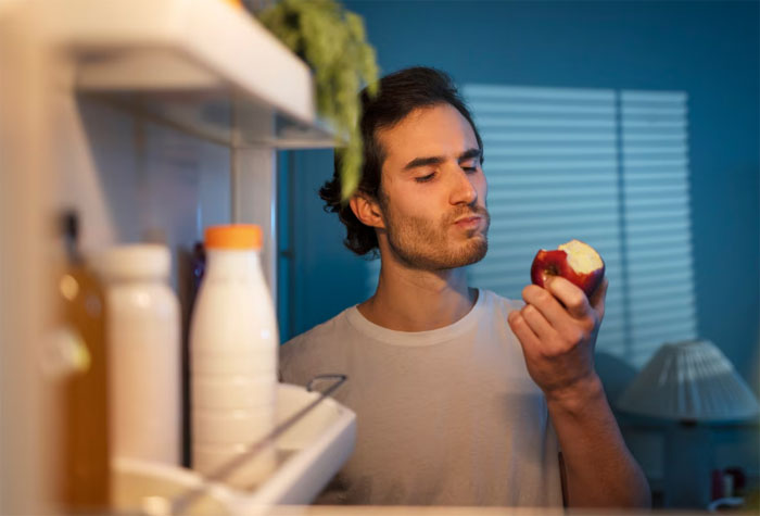 Man eating apple