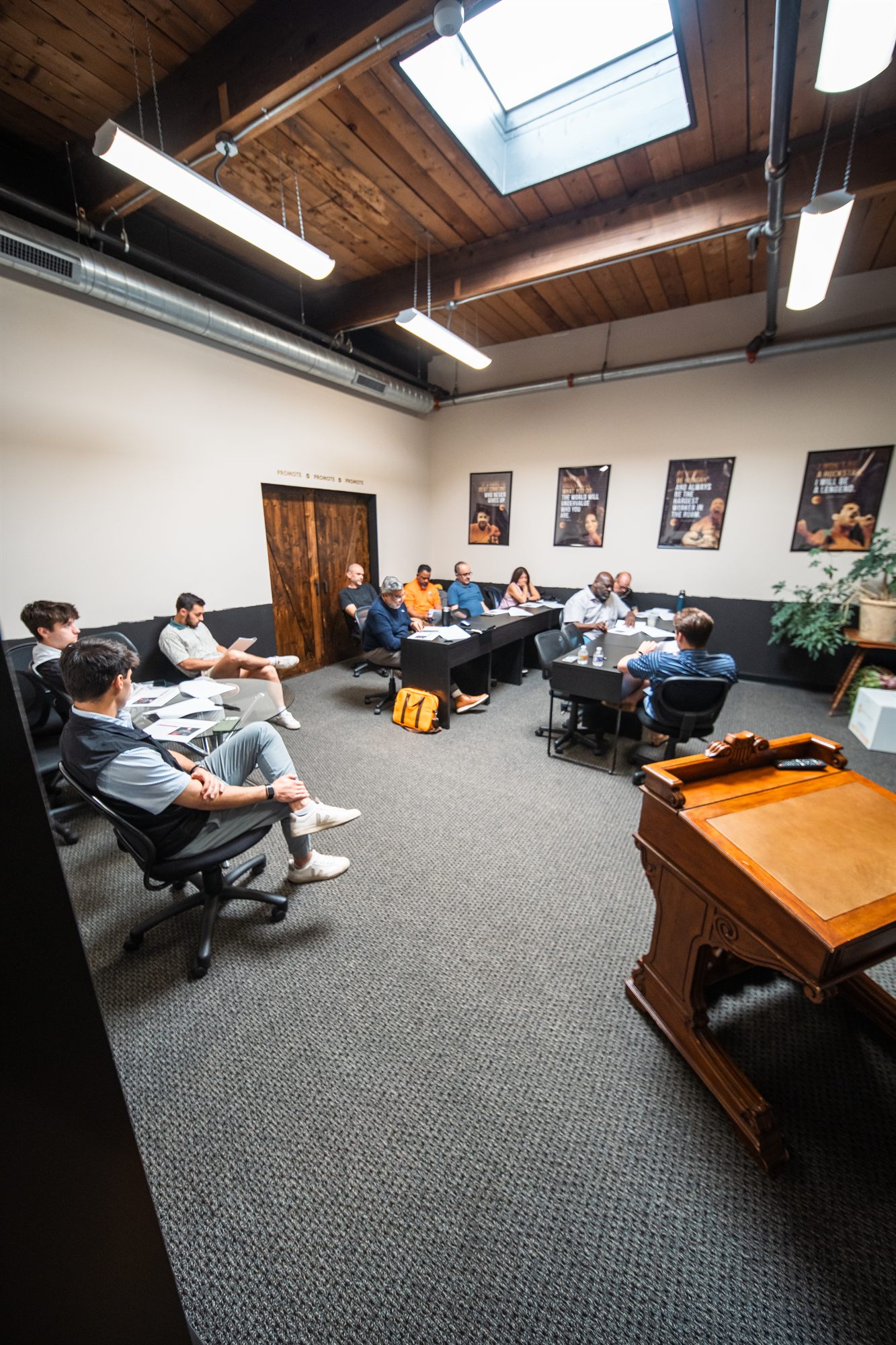 Wide view of the training session with Realty One Group under the skylight and timber ceiling