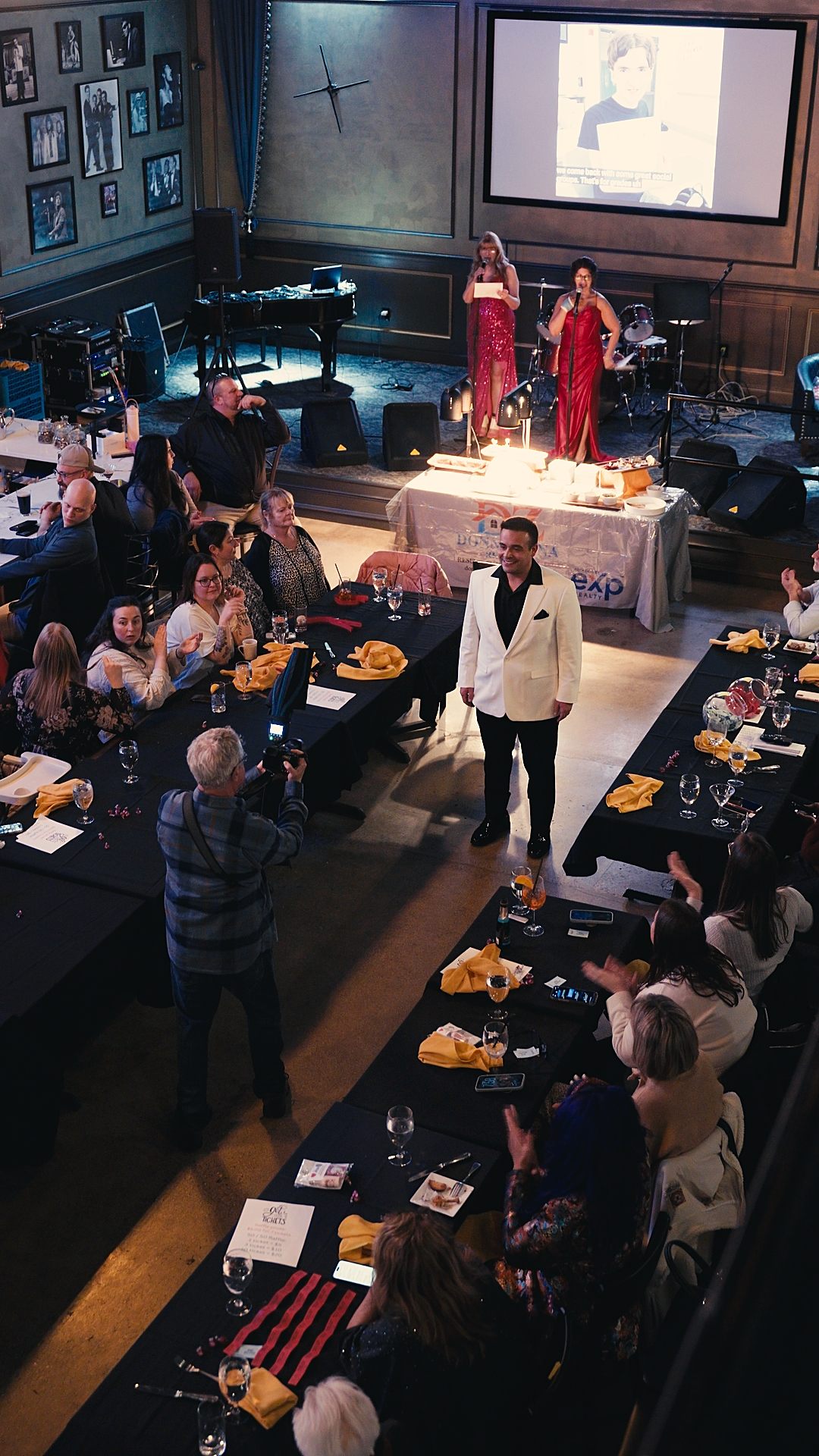 Overhead view of the packed room as a model walks the runway