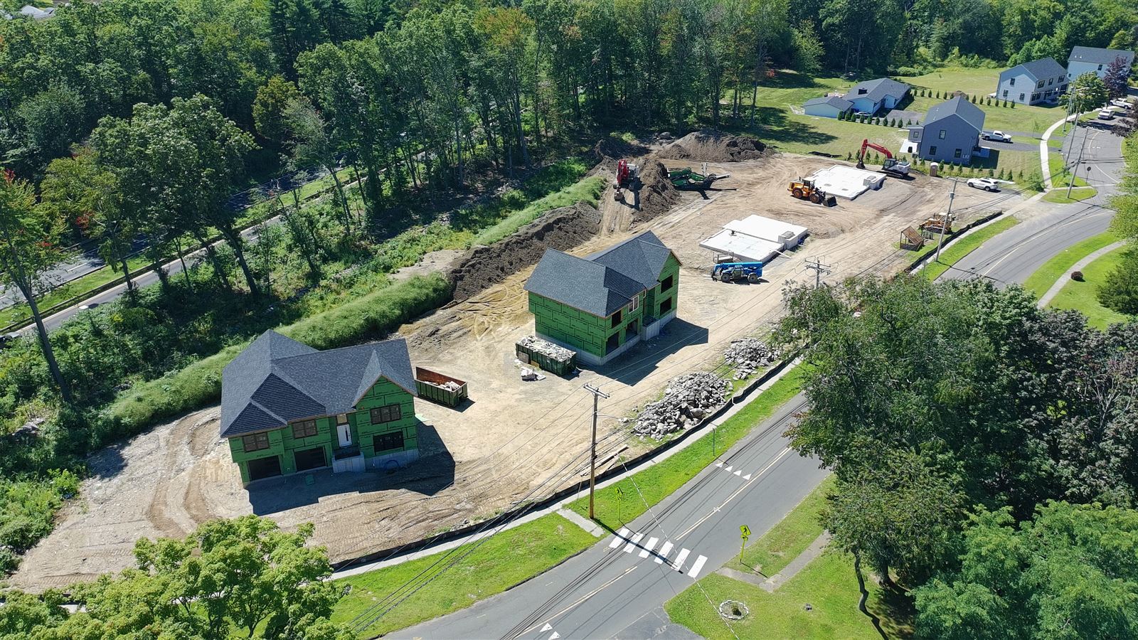 Aerial drone photo of the James Farm Road site in Stratford CT showing two framed homes and two poured foundations