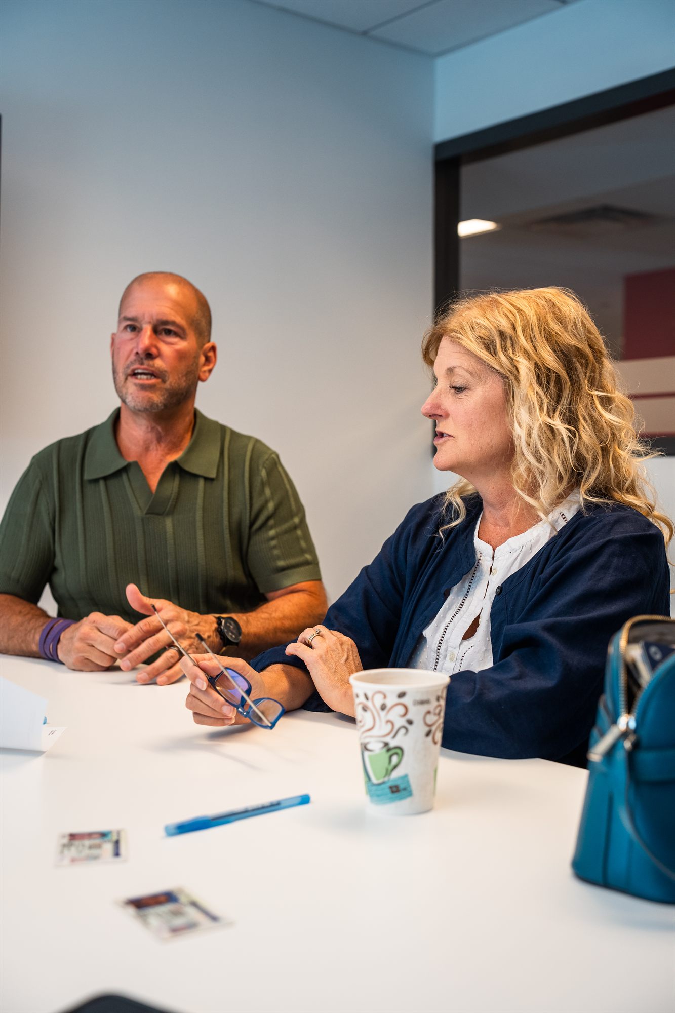 AFC senior team members talking over coffee at the conference table