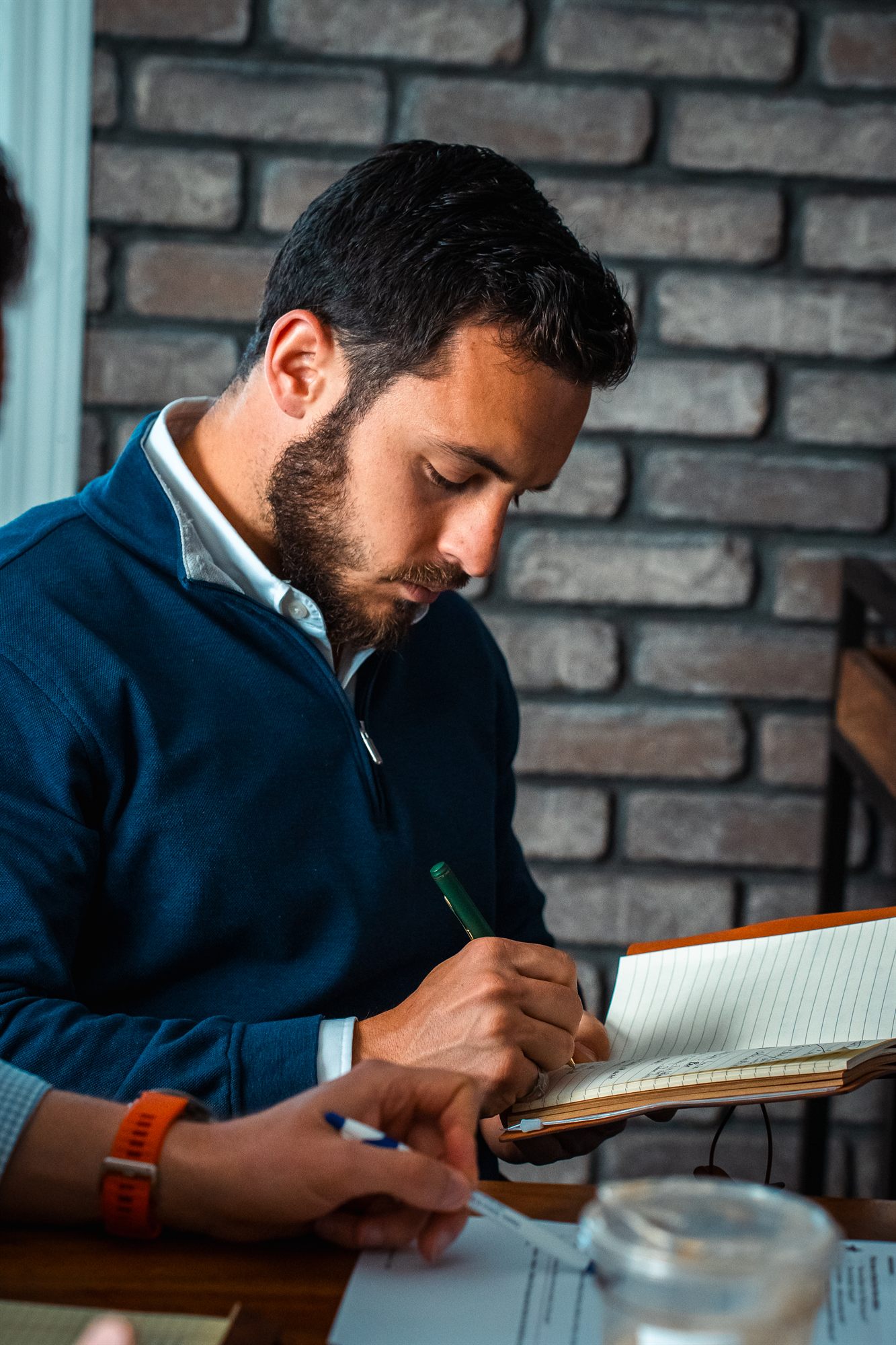 AFC team member writing notes at the sales meeting