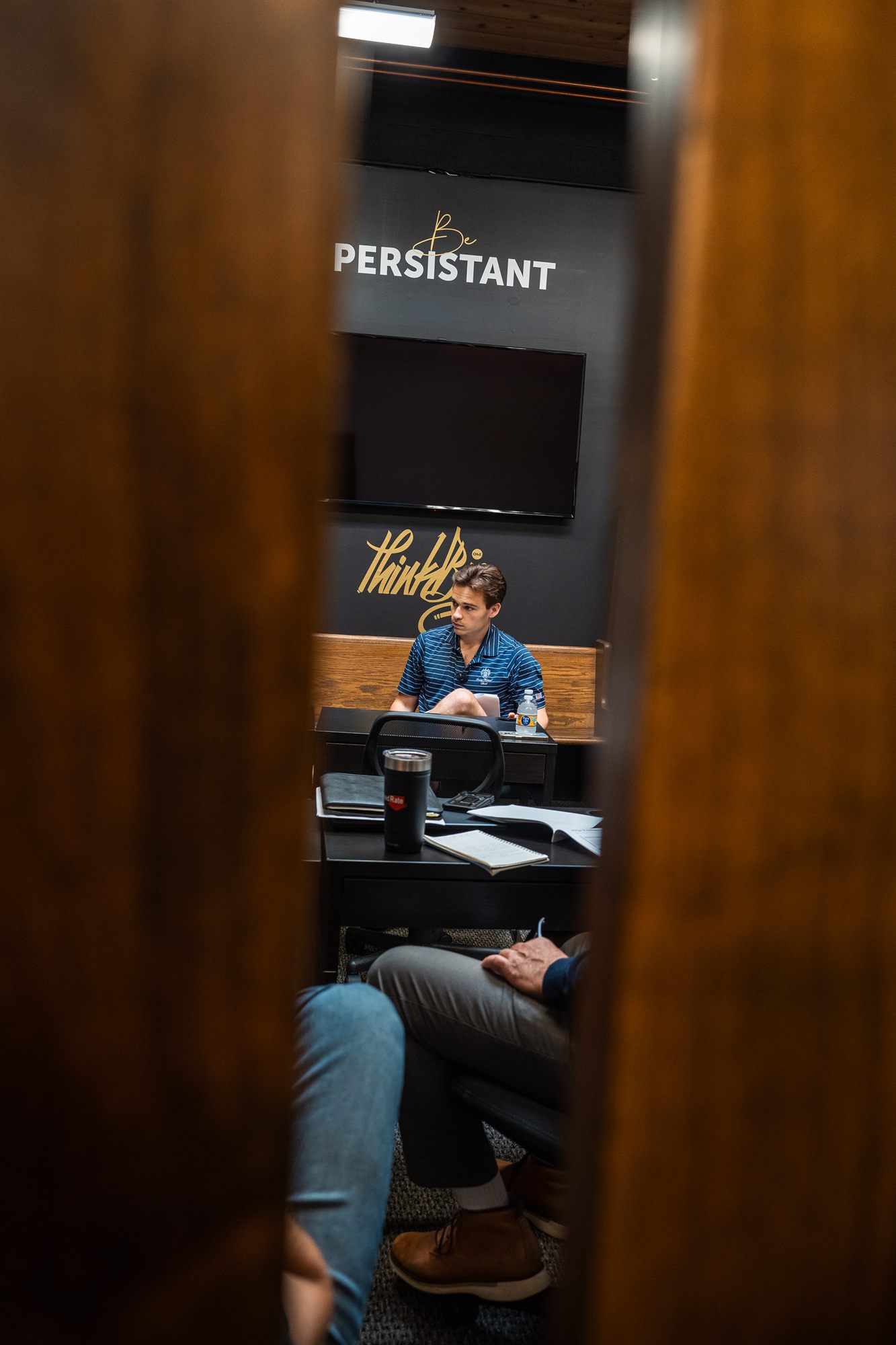 AFC team member focused between the training room doors
