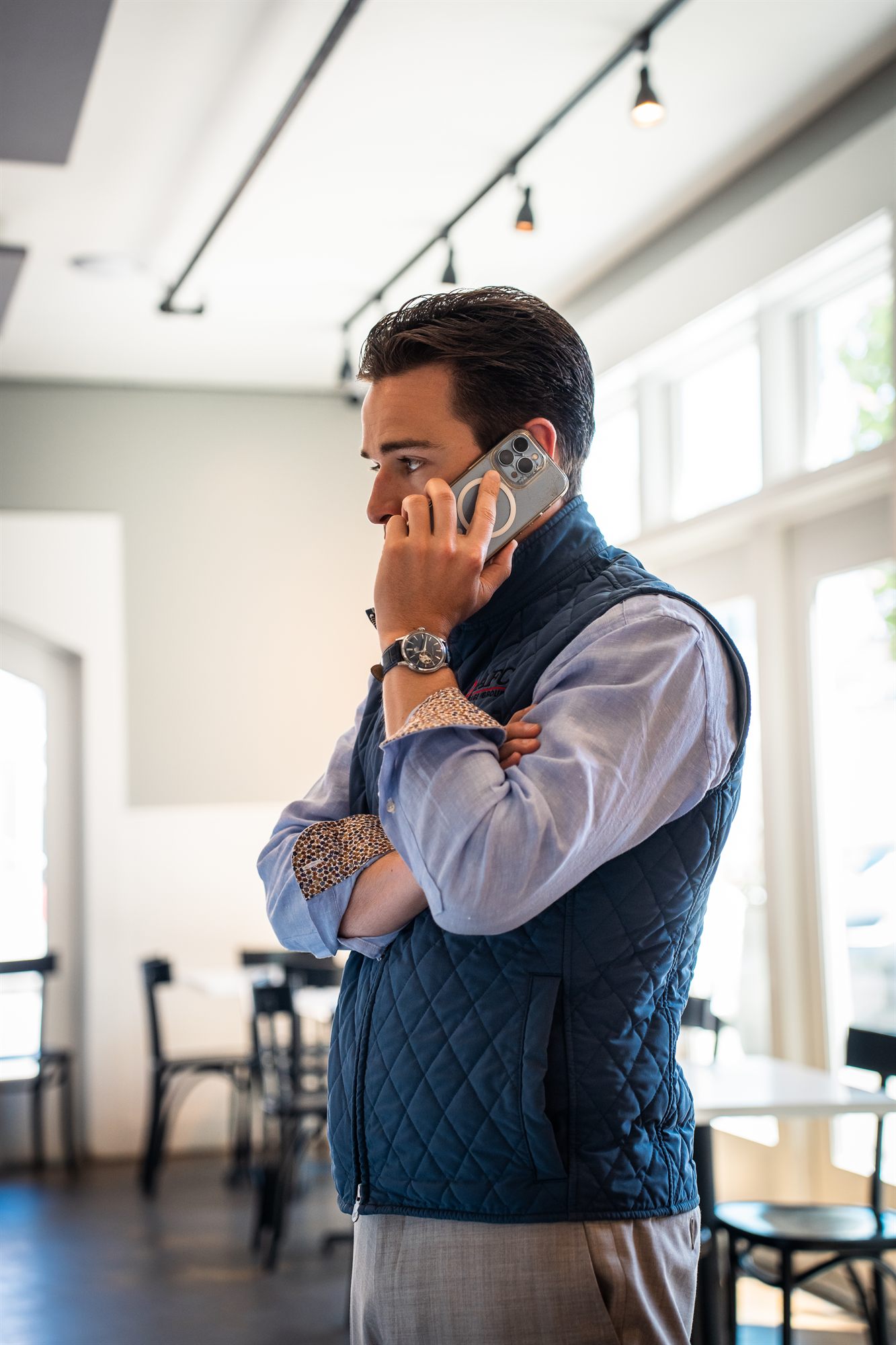 AFC loan officer taking a call in a bright cafe