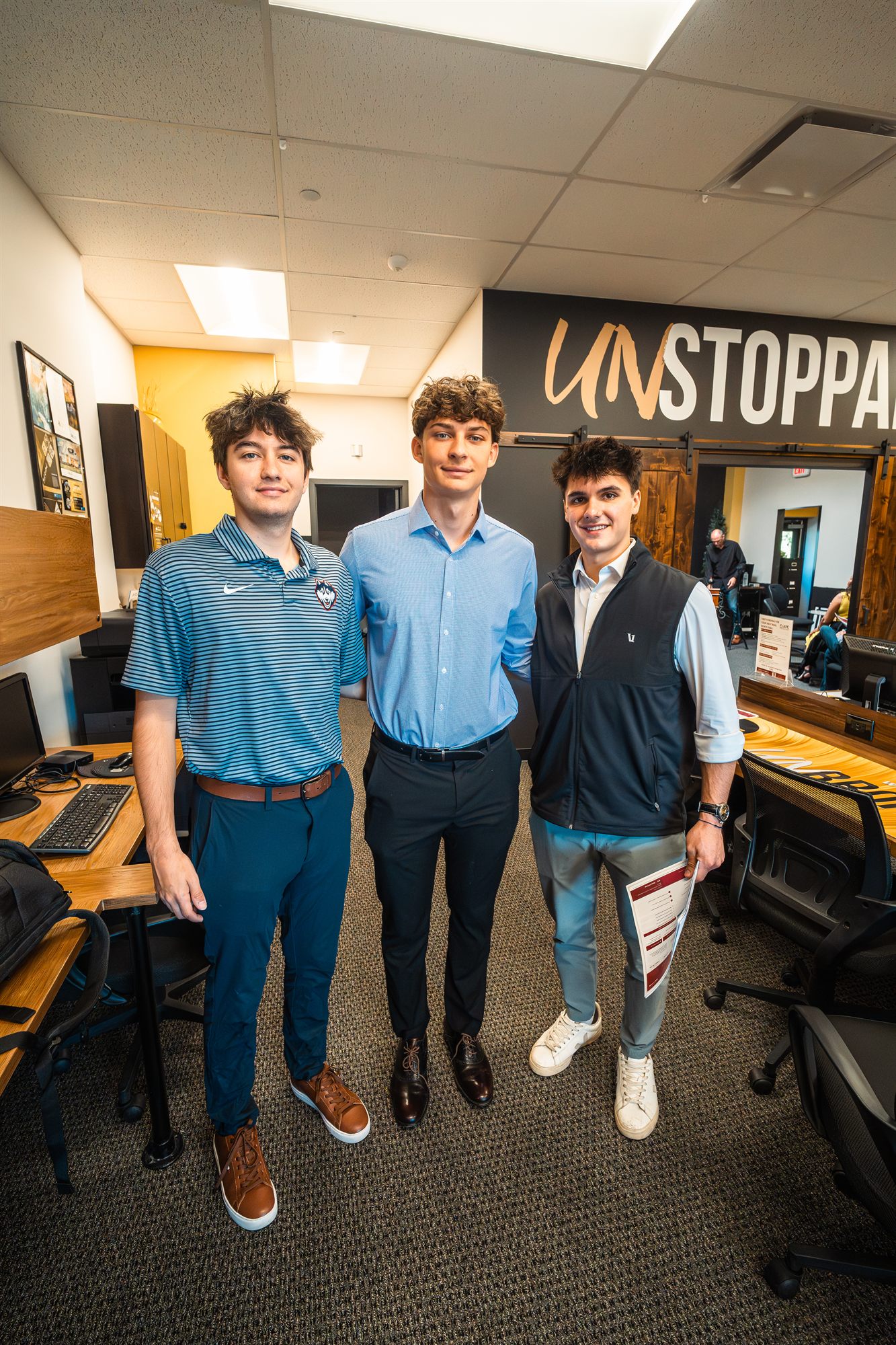 AFC summer interns smiling under the UNSTOPPABLE wall