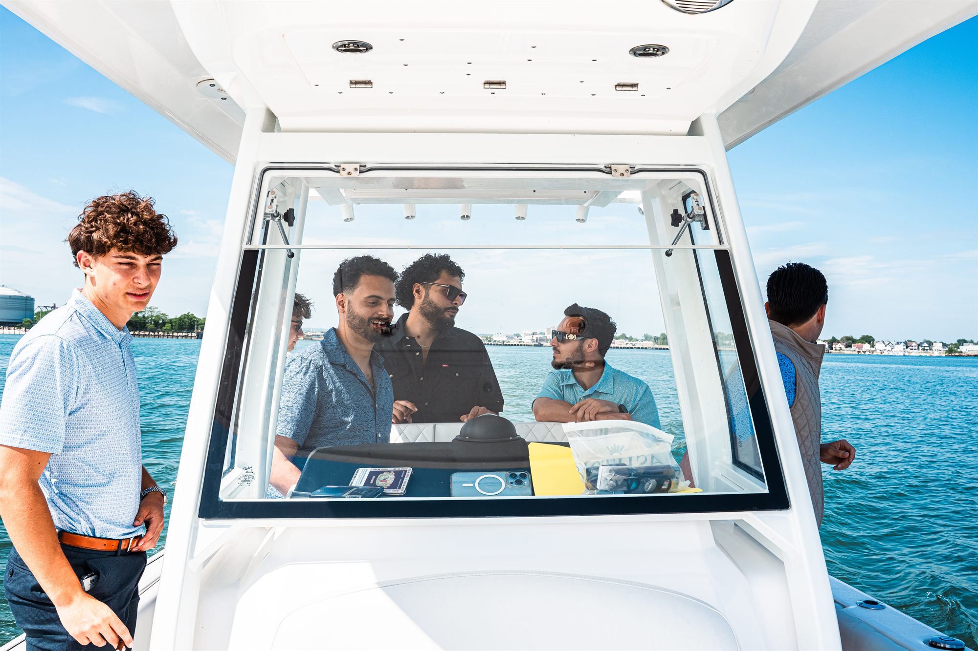 AFC Mortgage Group team laughing around the boat console