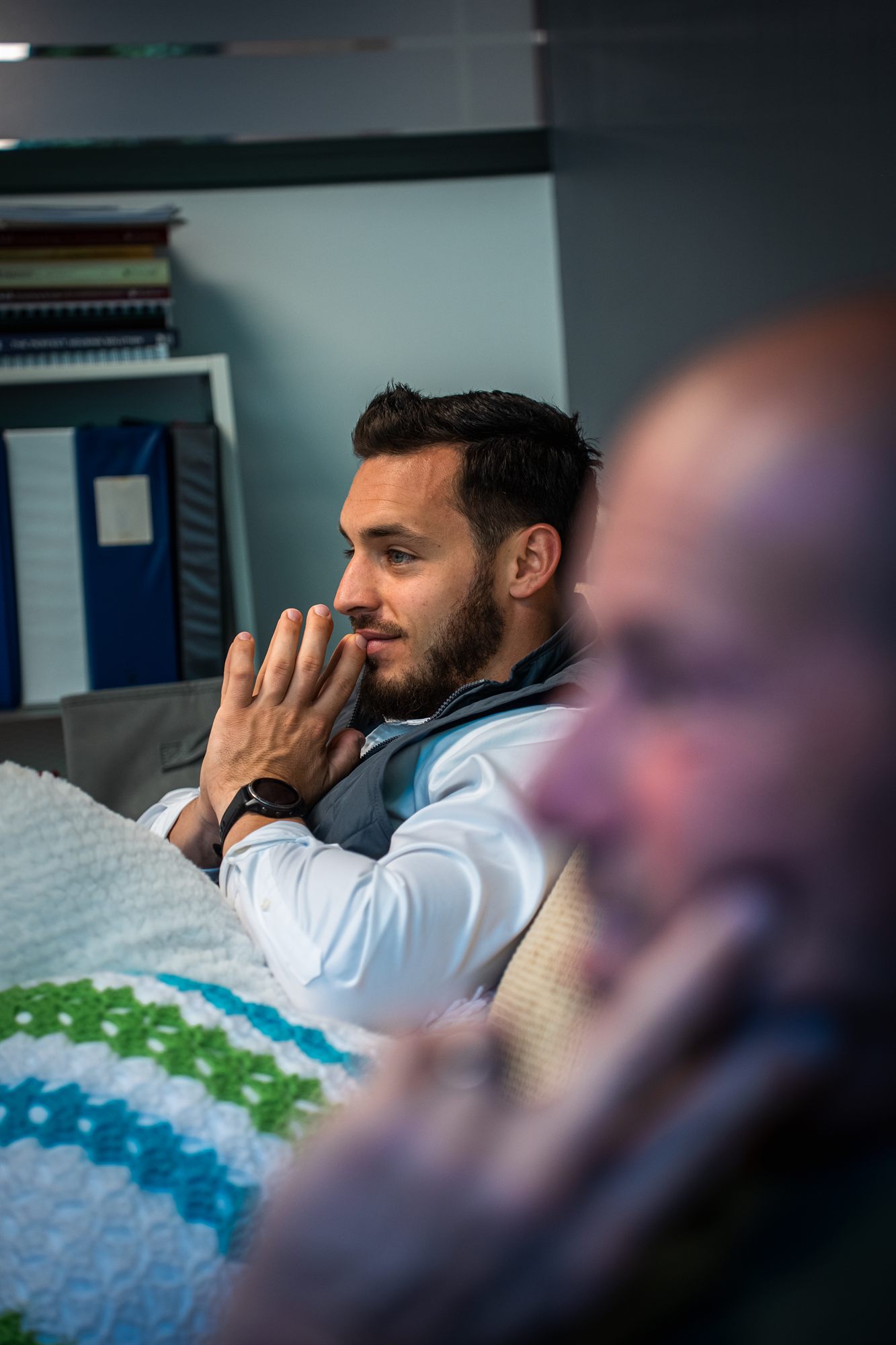 AFC team member listening closely in a meeting
