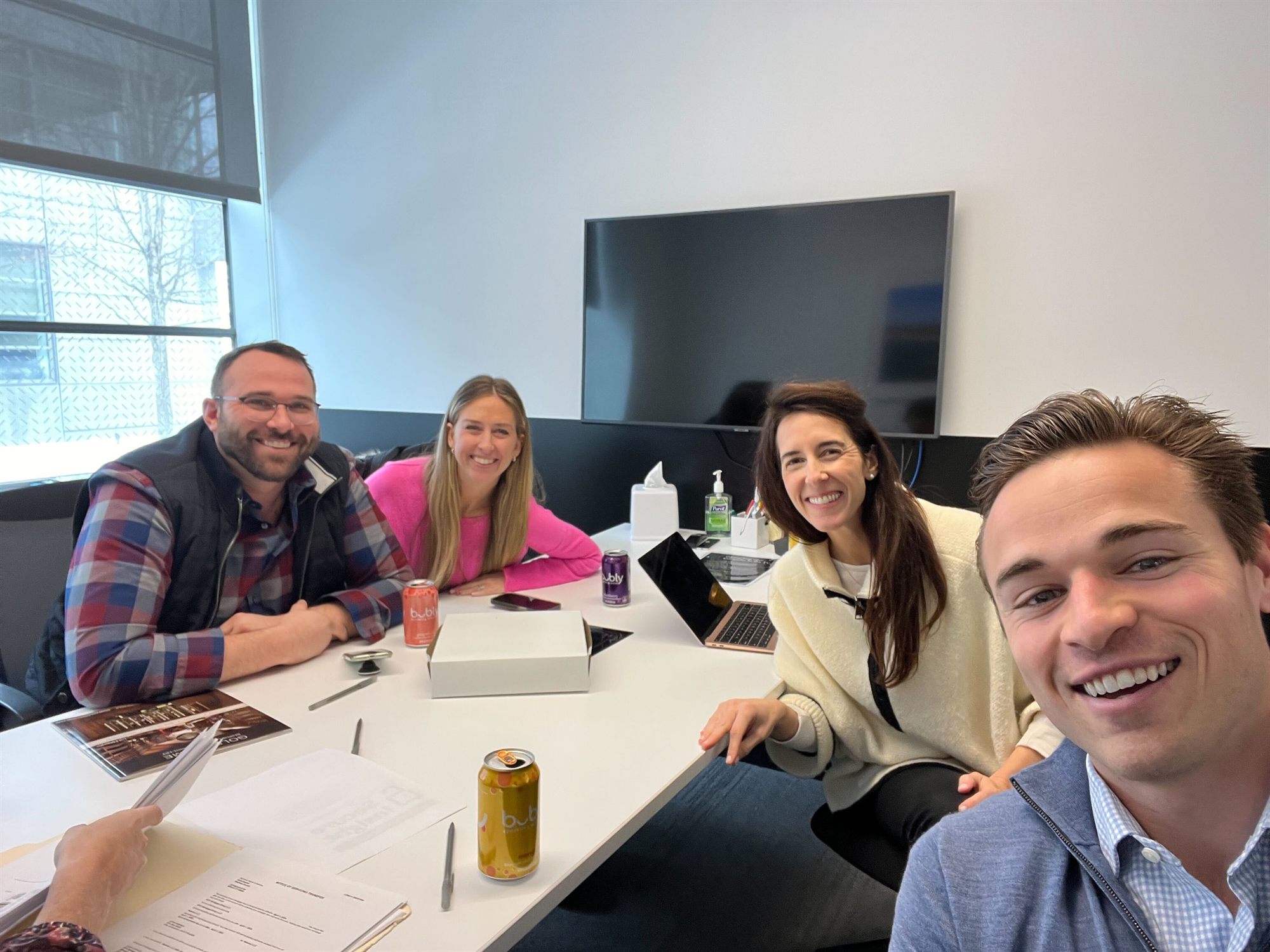 Matt and Kaila smiling in a bright conference room on closing day