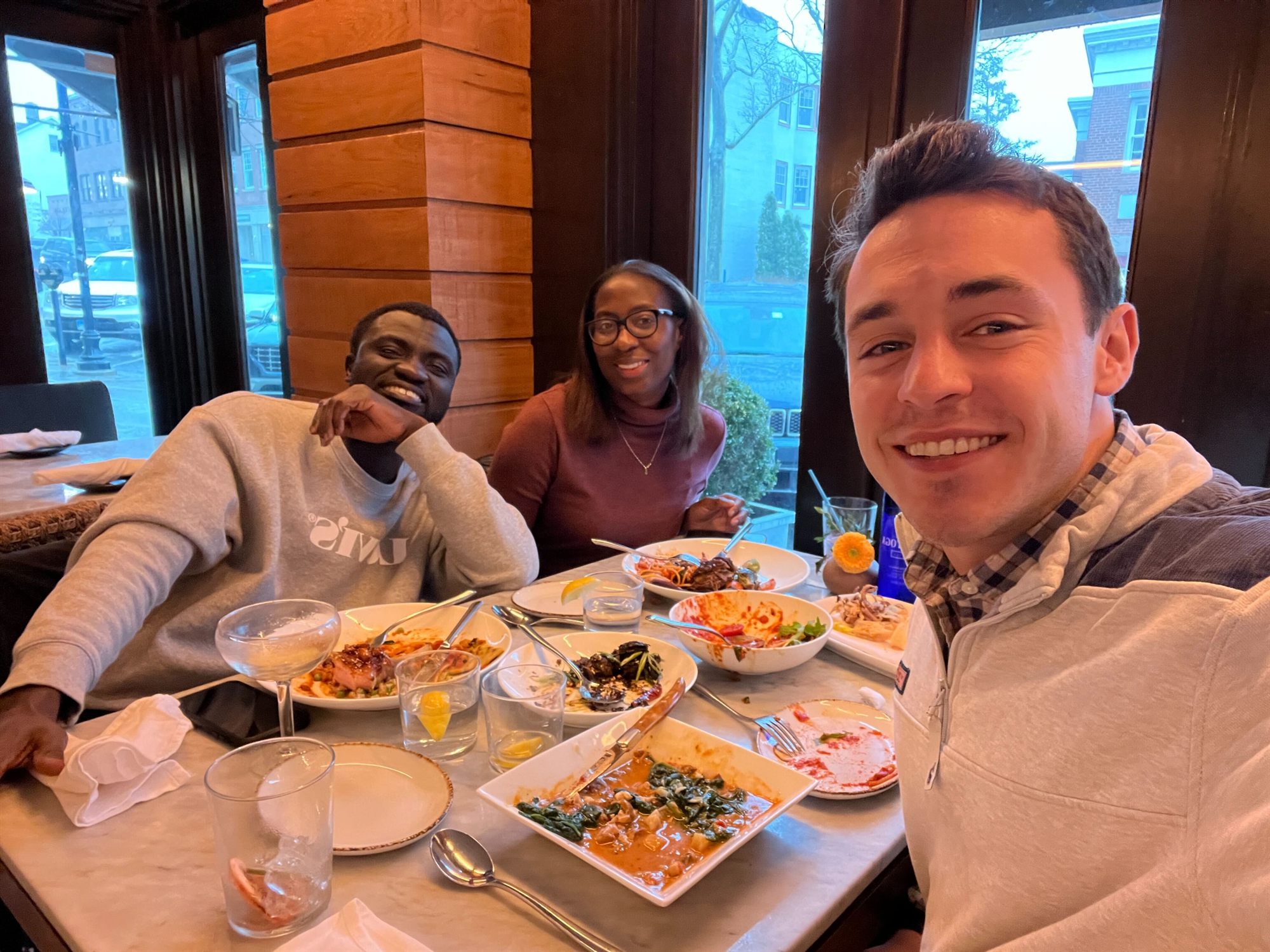 Elvina and Kwasi celebrating closing day over dinner