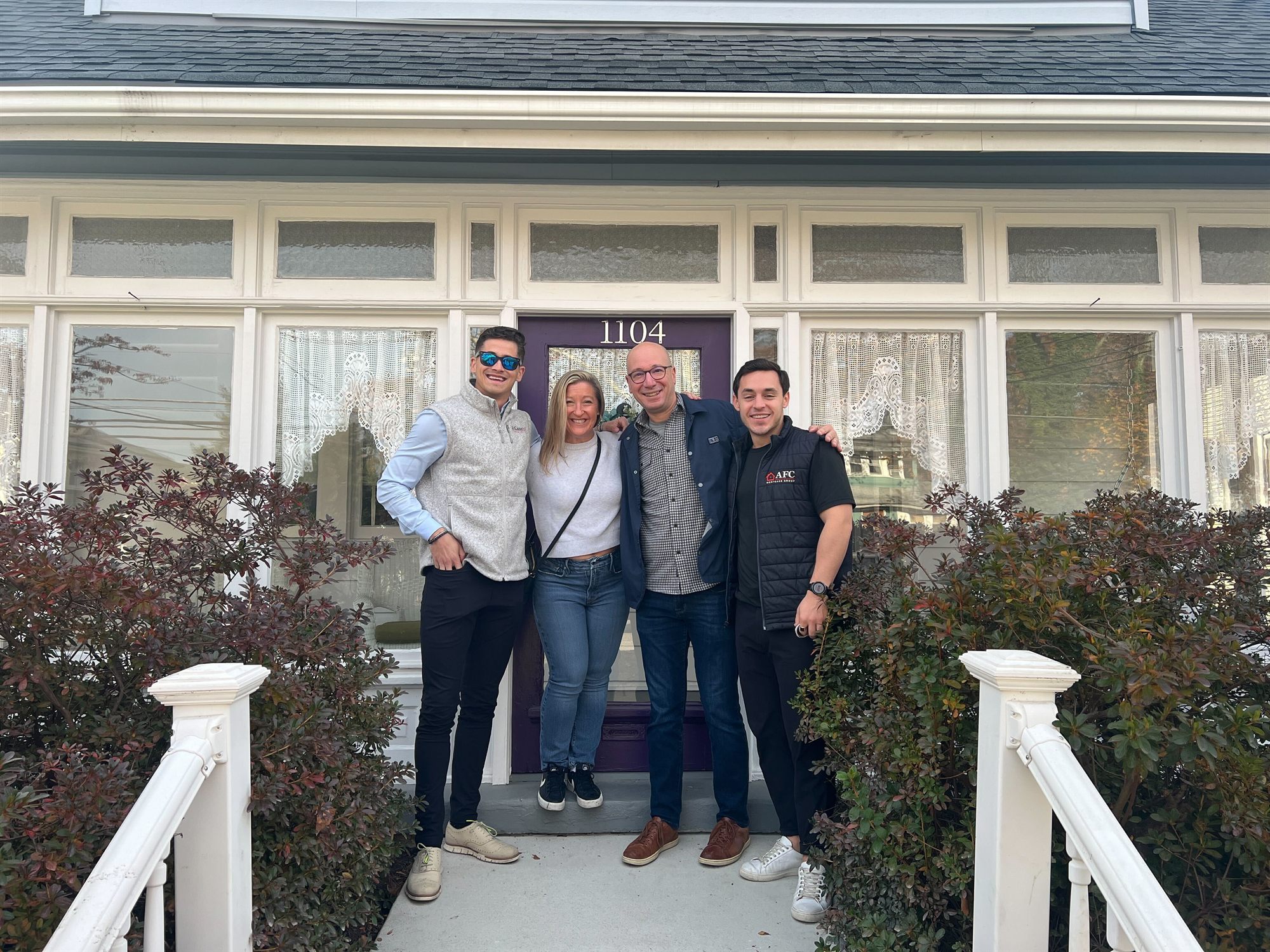 Amanda and Joe standing at the front door of their new home