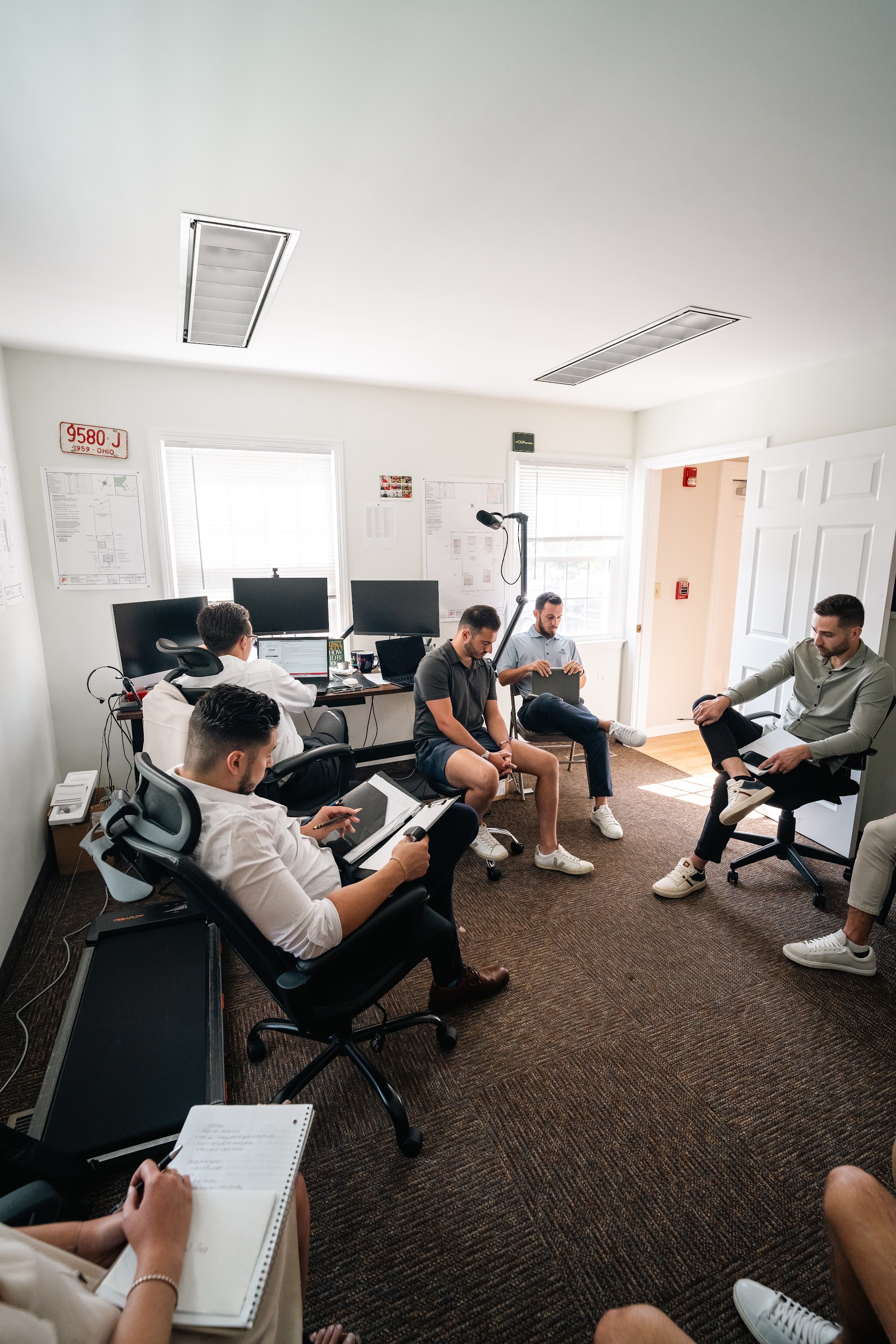 The AFC team gathered in a circle in the office for the Monday morning huddle