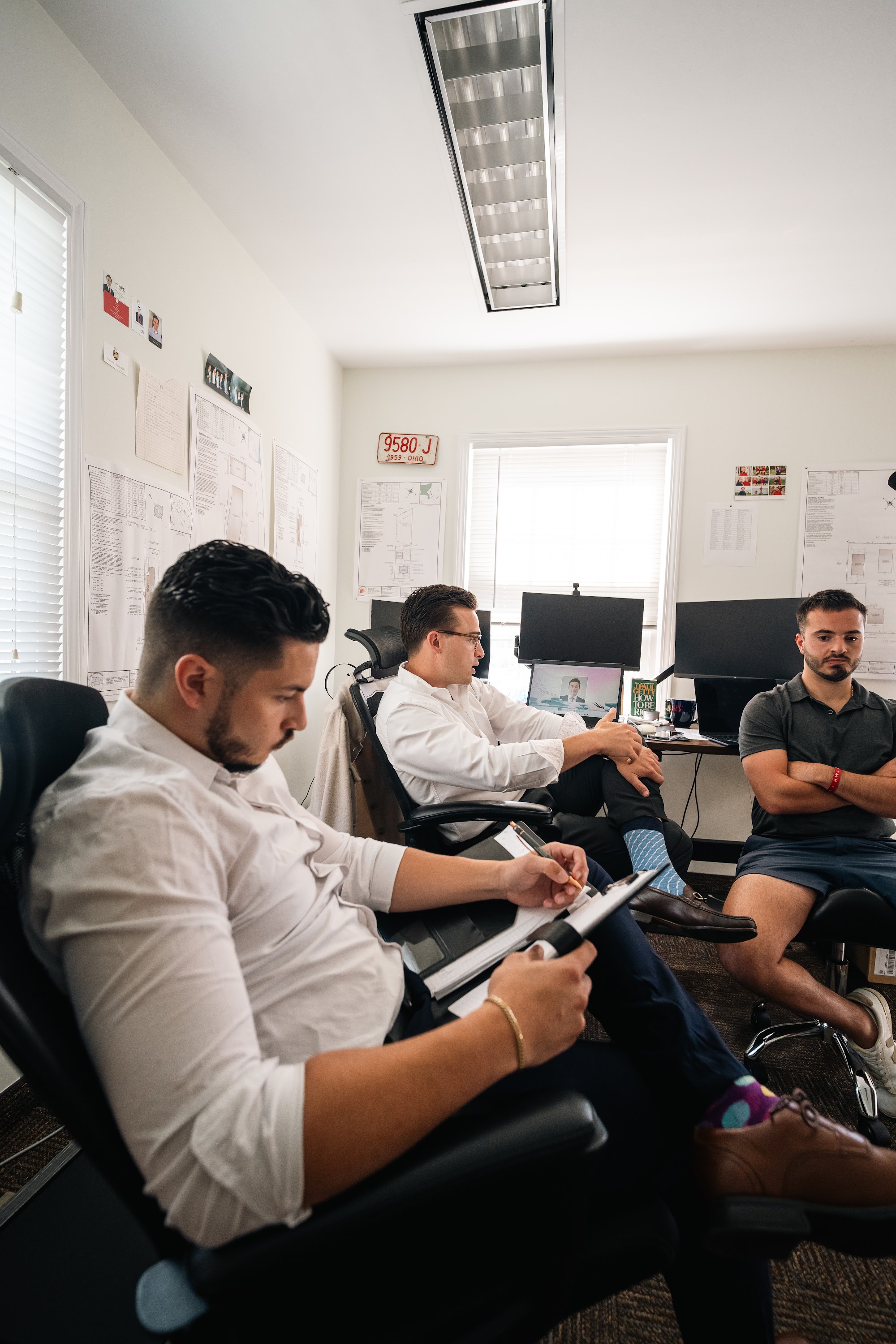 AFC team members taking notes during the Monday morning huddle