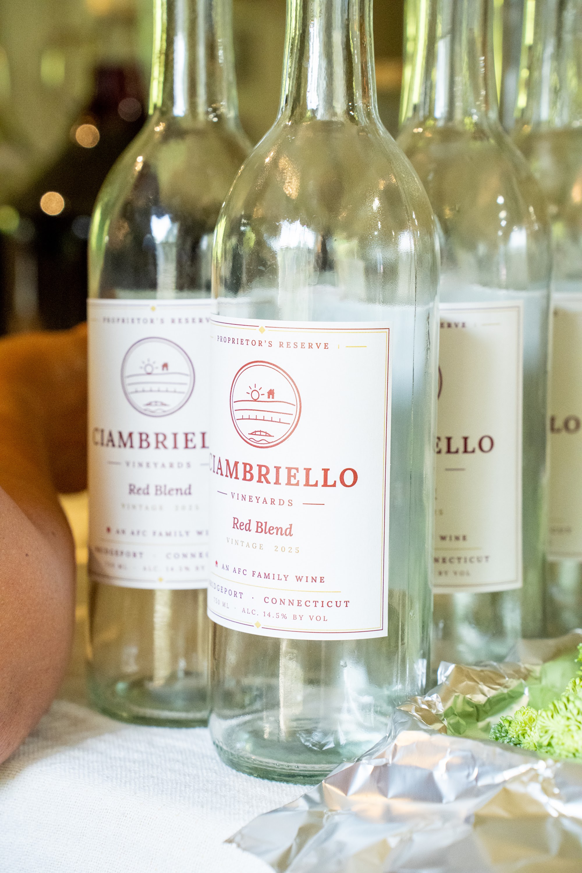 Bottles of Ciambriello Vineyards red blend lined up on the table
