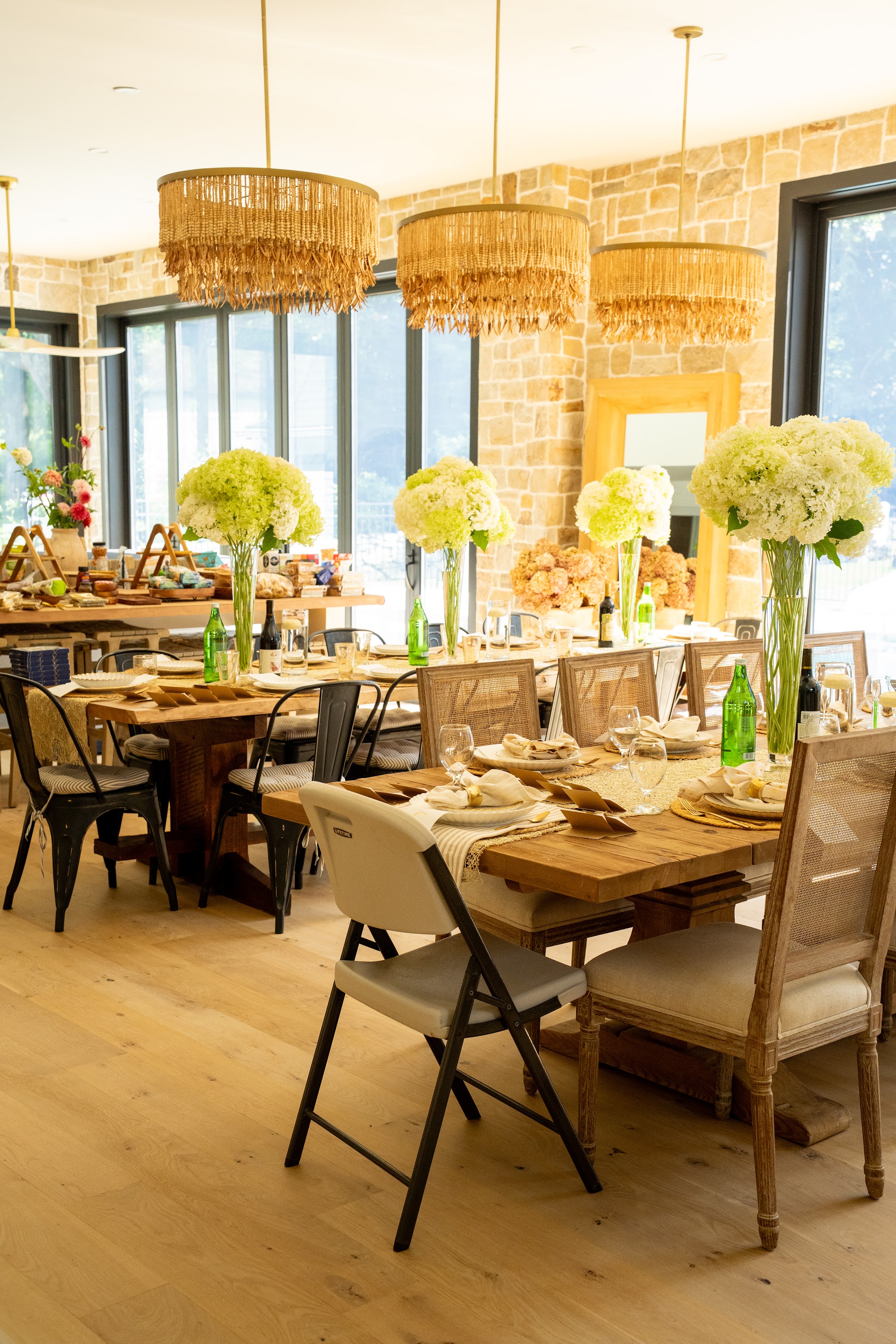 Dining room set with white hydrangea centerpieces before the investor dinner