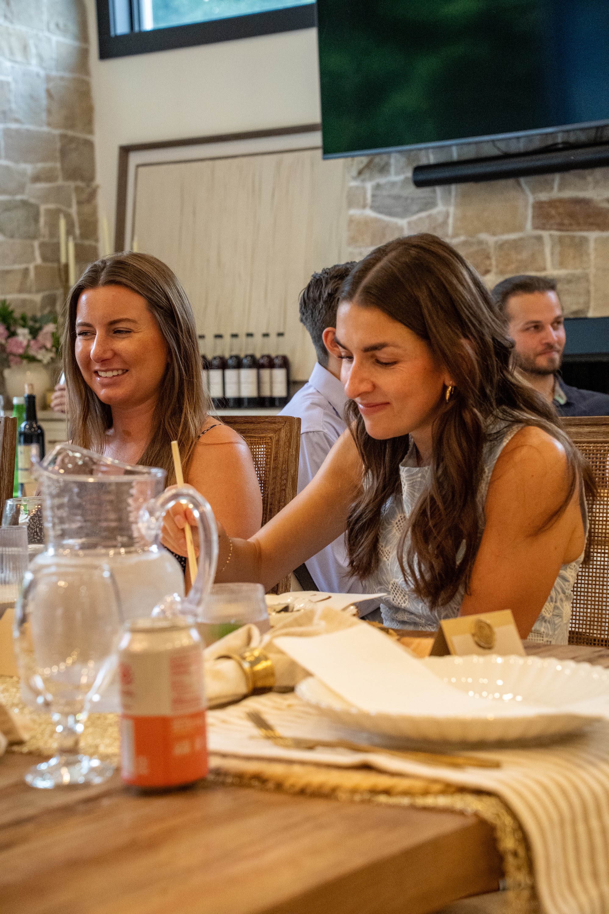 Two guests smiling at the dinner table
