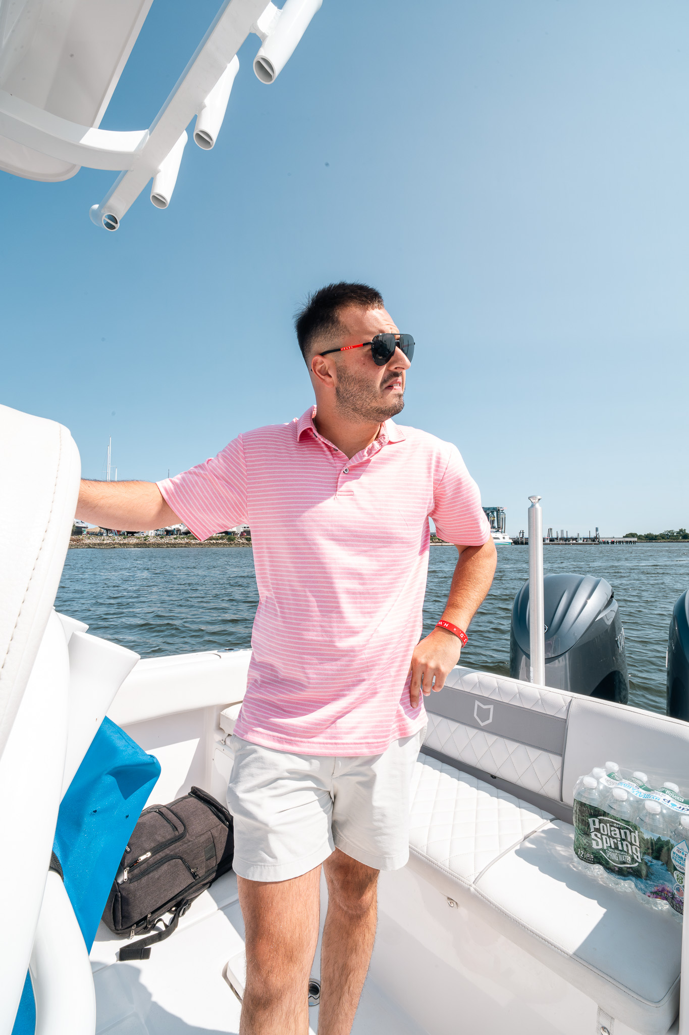 Team member standing on the boat deck on a sunny Friday