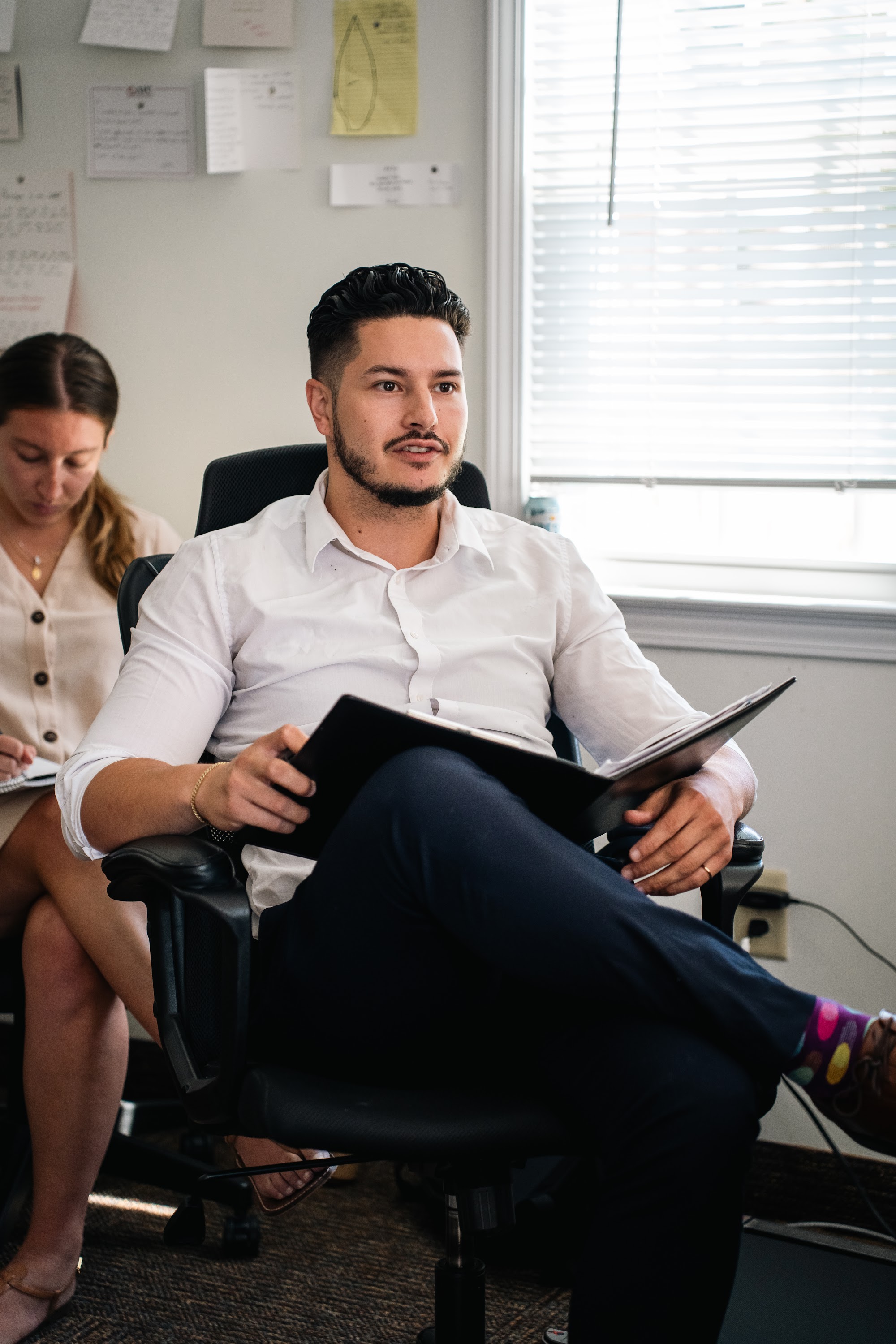 AFC interns seated on the office couch during the morning huddle