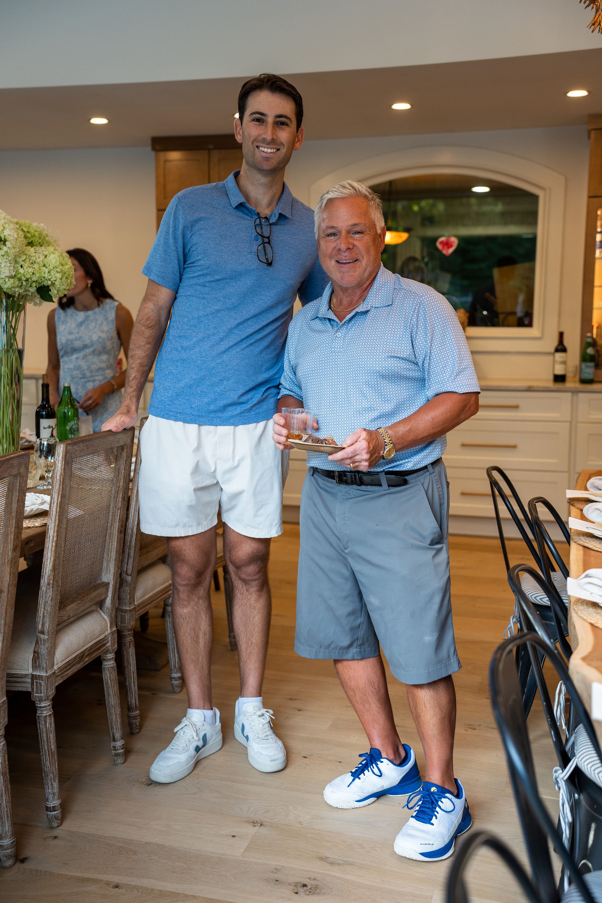 Two guests posed with a small gift in the dining room